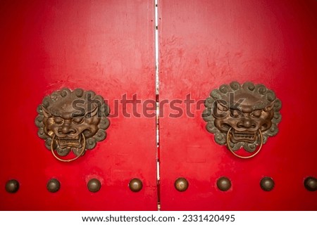 The doorknob at the back gate of the Sam Poo Kong temple have a typical Chinese design in the shape of a lion's head. Sam Poo Kong Temple is a famous tourist destinations in Semarang, Indonesia.