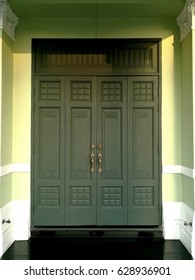 Doorknob and Metal door hsndle on Vintage green door.