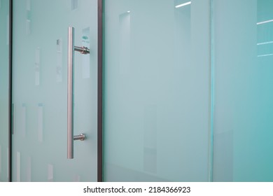 Doorknob On Close Glass Door In Office. Detail Of Contemporary Doorknob For A Glass Door In Office