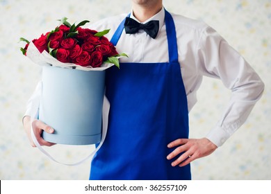 Doorman With Bouquet Of Red Roses In Box. Delivery Of Flowers.