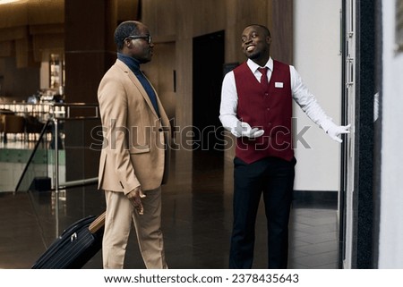 Doorman calling the elevator to the guest