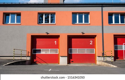 Doors of a fire station with numbers and trucks hidden behind them.