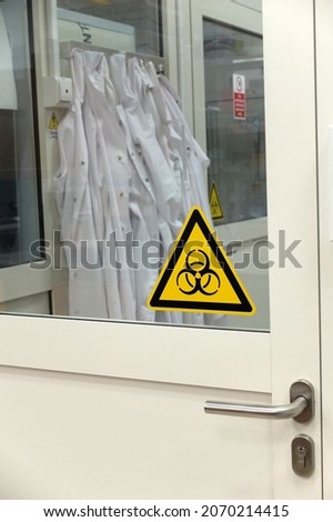 Doors leading to the cell and tissue culture laboratory in a research facility at the Faculty of Pharmacy of a medical university. Doors are labelled with biohazard sticker indicating potential risks