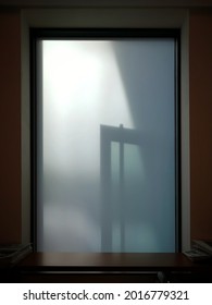 door's shadow on the window