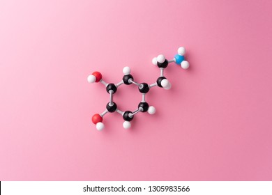 Dopamine cheimcal formula over pink background - Shutterstock ID 1305983566