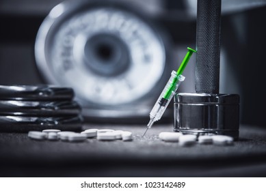 Dope In Sports. Dumbbell, Syringe Drugs On Black Background