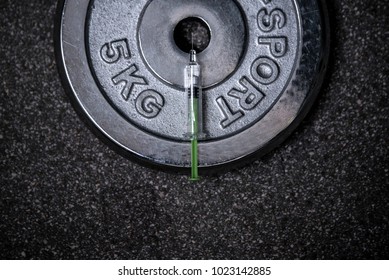 Doping In Sport And Steroid Abuse Concept With A Dumbbell,