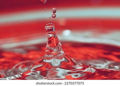 doplet of water impact to the water surface on colorful backround