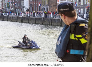 DORDRECHT, THE NETHERLANDS - APRIL 27, 2015: Police Officer On Jetski Patrolling The Harbor In Dordrecht During The Visit Of The Dutch Royal Family During The Traditional Kings Day Celebrations.