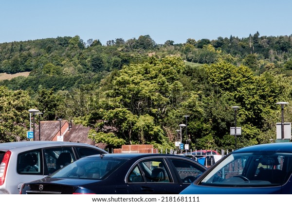 Dorking Surrey\
Hills UK, July 10 2022, Public Council Car Park With Parked Cars\
Against Surrey Hills And Blue\
Sky