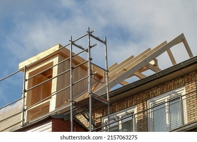 dormer installation on the rooftop of a apartment house - Shutterstock ID 2157063275