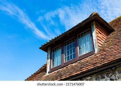 Dormer window in a traditional style Sussex cottage with flint walls, red clay tiles and leaded windows