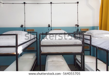 Dormitory room with bunk beds in new hostel for students or travelers.