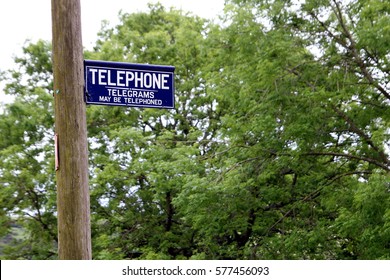 Dorset, UK - May 31st 2016: Vintage British Telephone And Telegram Sign On A Traditional Wooden Pole.