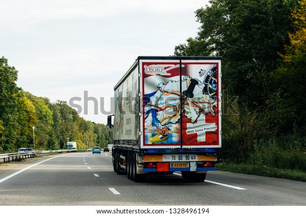 Dortmund, Germany - Nov 7, 2017: Rear view of\
truck cargo delivery from LTT company with the slogan Swiss\
Precision delivery