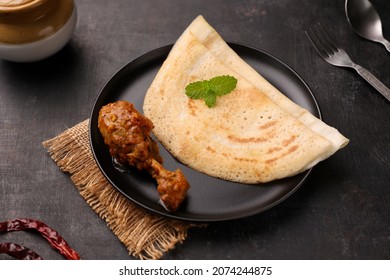 Dosa , Dosai, Ghee Roast With Chicken Curry Popular South Indian Breakfast Food, Kerala, Tamil Nadu India Sri Lanka. Masala Dosa With Non Vegetarian Indian Kadai Chicken Leg Curry.