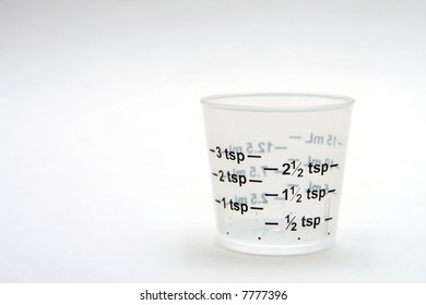 Dosage Cup On White Background, Bottom Right