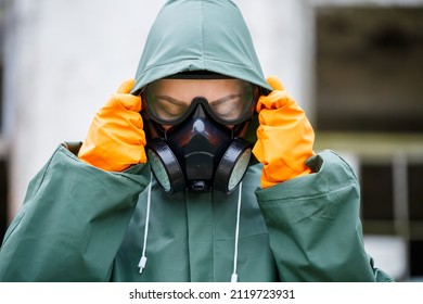 A Dosimetrist Scientist In Protective Clothing And A Gas Mask Checks The Level Of Radioactive Radiation In The Danger Zone. Environmental Pollution, Disaster