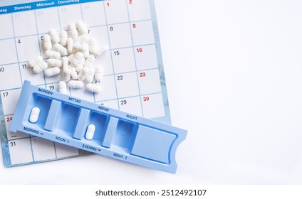 Dosing of pills by days, many pills are on the calendar and in the pillbox, organizer for pills on a white background with copy space. - Powered by Shutterstock