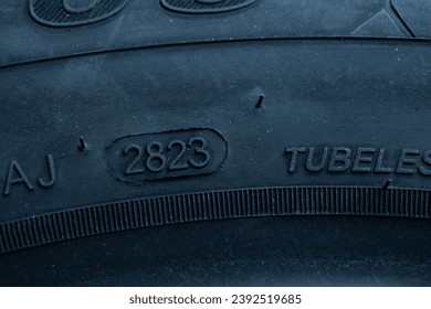 
Dot code and date of production of the tire on the sidewall of the wheel. Close up. Tire shelf life.