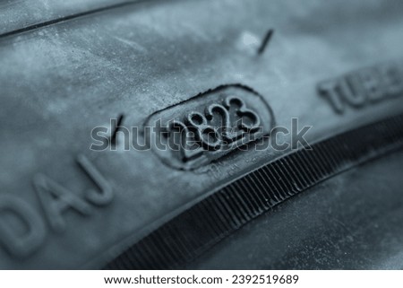 
Dot code and date of production of the tire on the sidewall of the wheel. Close up. Tire shelf life.