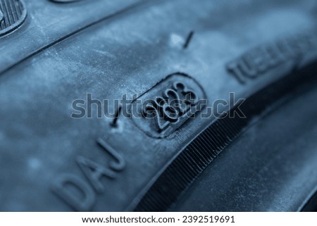 
Dot code and date of production of the tire on the sidewall of the wheel. Close up. Tire shelf life.