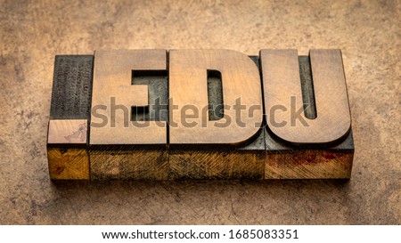 dot edu internet domain  - network address  for education - text in vintage letterpress wood type against textured bark paper