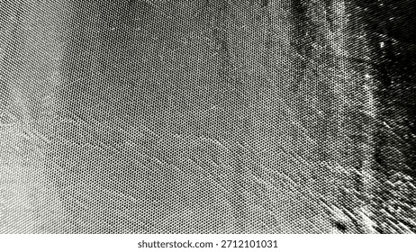 dotted texture surface with gradient shading and curved form in grayscale abstract closeup