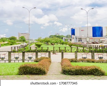 Douala, Littoral/Cameroon - 11/12/2019 : A nice view on a nice open park with the biggest shopping center of the city of Douala and a petrol station on the right in the heart of Douala - Cameroon 