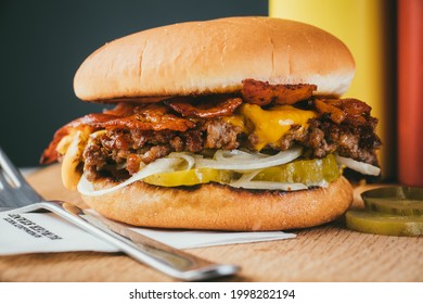 Double Bacon Cheeseburger On A Table