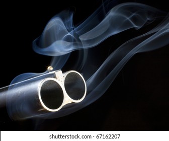 double barreled shotgun with both of the barrels smoking