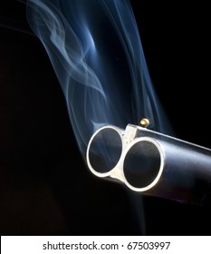 Double Barreled Shotgun With Smoke Coming Out Of Both Barrels