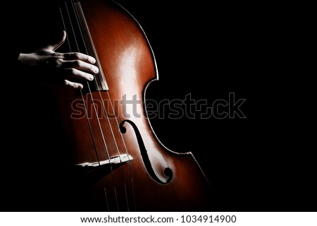 Double bass. Hands playing contrabass player musical instrument. Strings cello