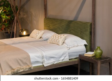 Double Bed, Bedroom With Wooden Elements, Marble And Wood Bedside Table, Green Vase, Green Headrest. Eco Design.