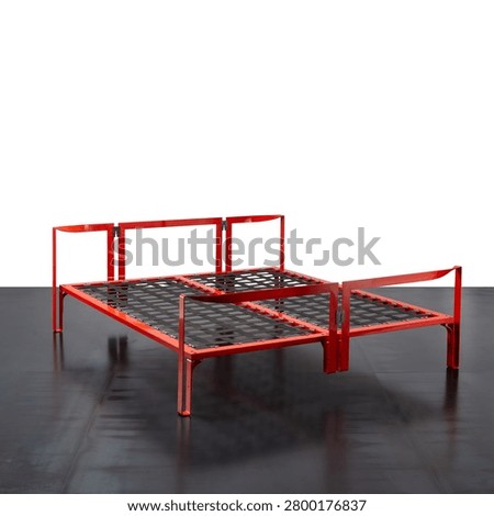 double bed, featuring a red enamelled metal frame and a strap base.