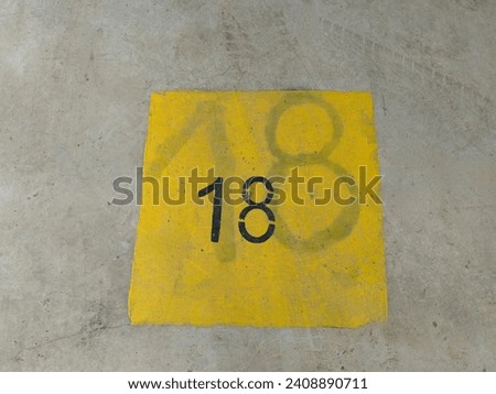 Double black 18 number, parking lot. Spot. Dirty place concrete floor