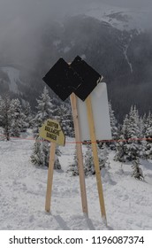 Double Black Diamond Sign At Ski Resort With Snow Covered Evergreens In The Background