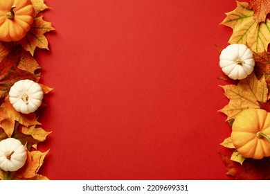 Double border frame of maple leaves and pumpkins on red background. Happy Thanksgiving Day or Halloween concept.