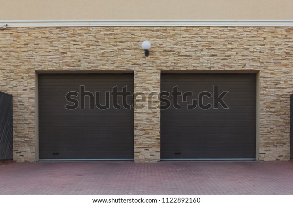\
Double\
brown shutters in the garage of a private\
house