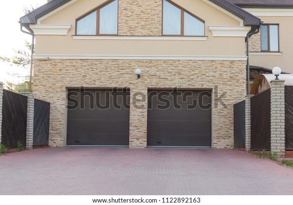\
Double\
brown shutters in the garage of a private\
house