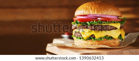 double cheeseburger with lettuce, tomato, onion, and melted american cheese with panoramic composition
