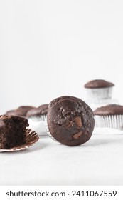 Double chocolate muffins on a white marble tray, dark chocolate muffins with a white background