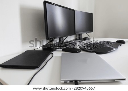Double computer laptops and monitors with keyboard, mouse also a docking station. Home workdesk concept. Advanced dual screens.