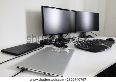 Double computer and monitors with keyboard, mouse and docking station. Home workdesk concept. Advanced dual screens.