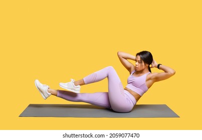 Double crunch excercise. Sporty african american lady working out on mat, doing bicycle crunch abs exercises over yellow studio background, free space - Shutterstock ID 2059077470