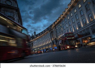 Double Decker Buses And Other Traffic On A Crowded Regent Street, The Shopping Center Of London That Connects Oxford Circus To Piccadilly Circus, At Night In England, United Kingdom