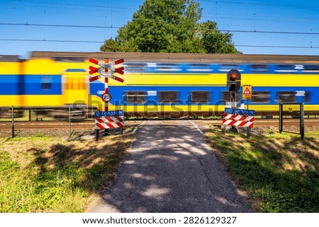 Double Decker Intercity Train passing an Unprotected Railway Crossing in Heiloo, North Holland, Netherlands