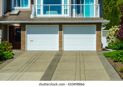 Double Doors Garage With Long Driveway.