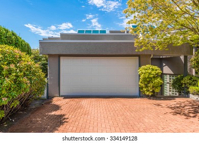 Double Doors Garage With Nicely Paved Driveway. North America.