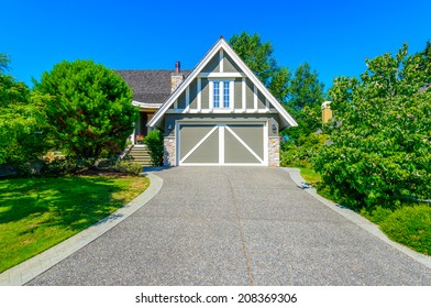 Double Doors Garage With Wide Long Driveway. Vertical.